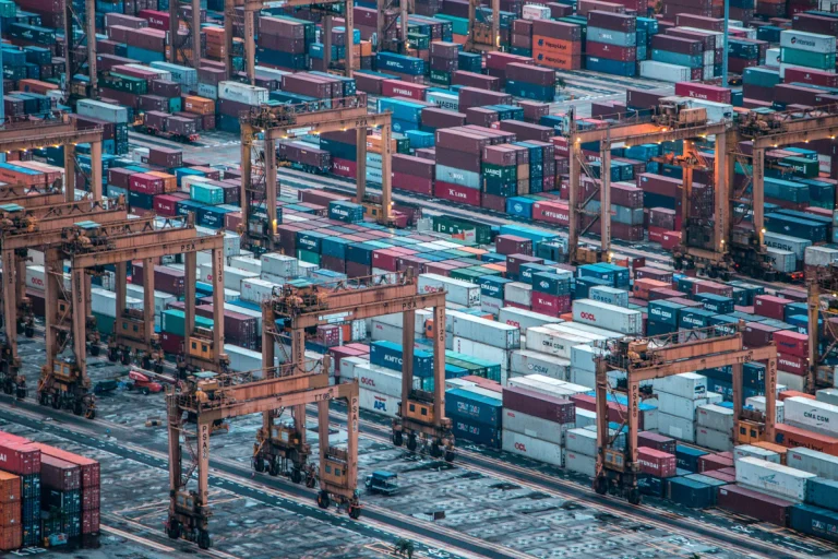 Aerial view of shipping containers and cranes at an international cargo port